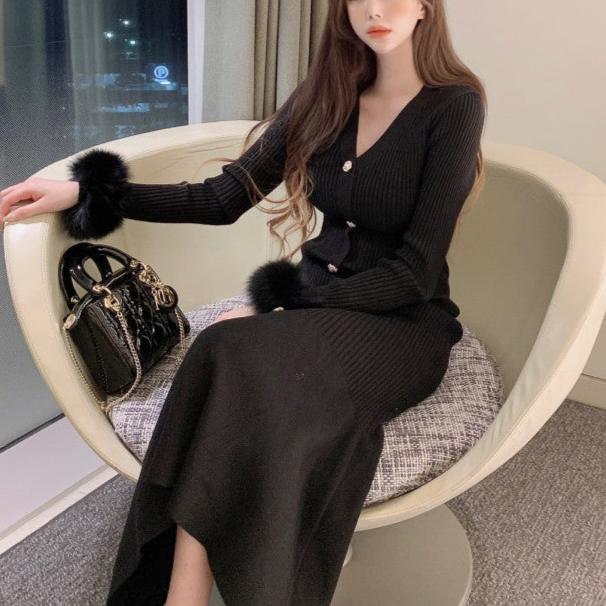 座って足を組むブラックワンピースの女性(セクシーな雰囲気)