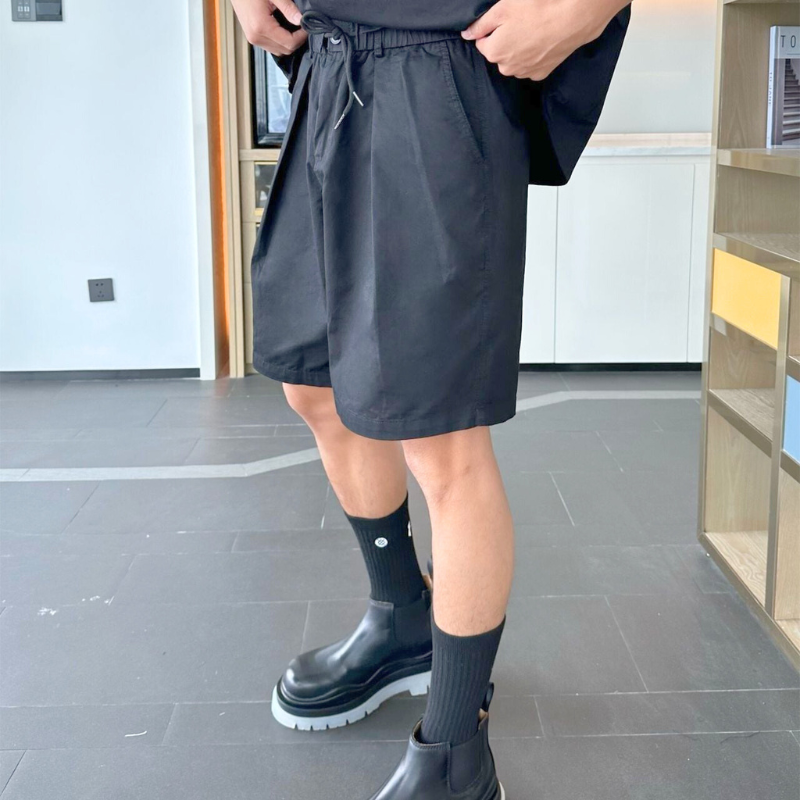 黒セットアップを着た横向きスタイル(太もも見せ)