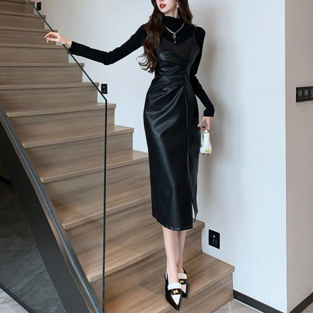 階段でクールに佇むフェイクレザーキャミワンピース&タートルネックセットの女性