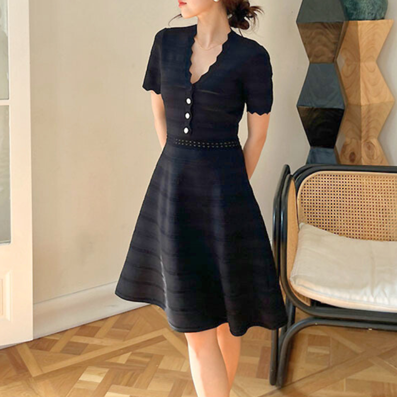 スカラップネックとボタンの装飾が映える黒ニットワンピ