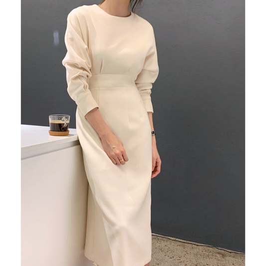 コーヒーを持ちゆるっとした袖を見せたワンピスタイル