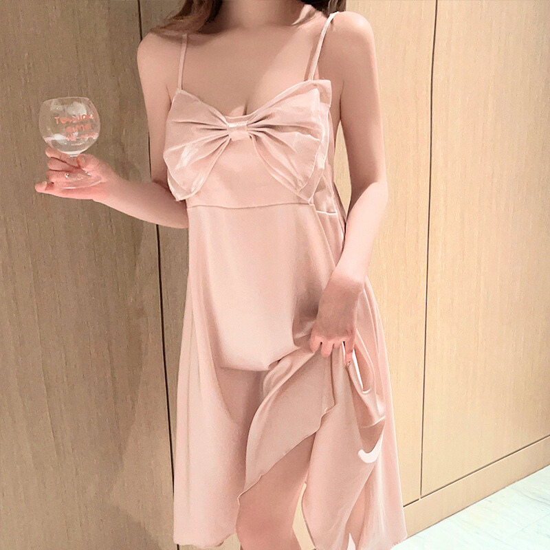 大きなリボンが胸元を彩るピンクのアイスシルクスリップドレス。背中開きデザインで特別な夜におすすめ