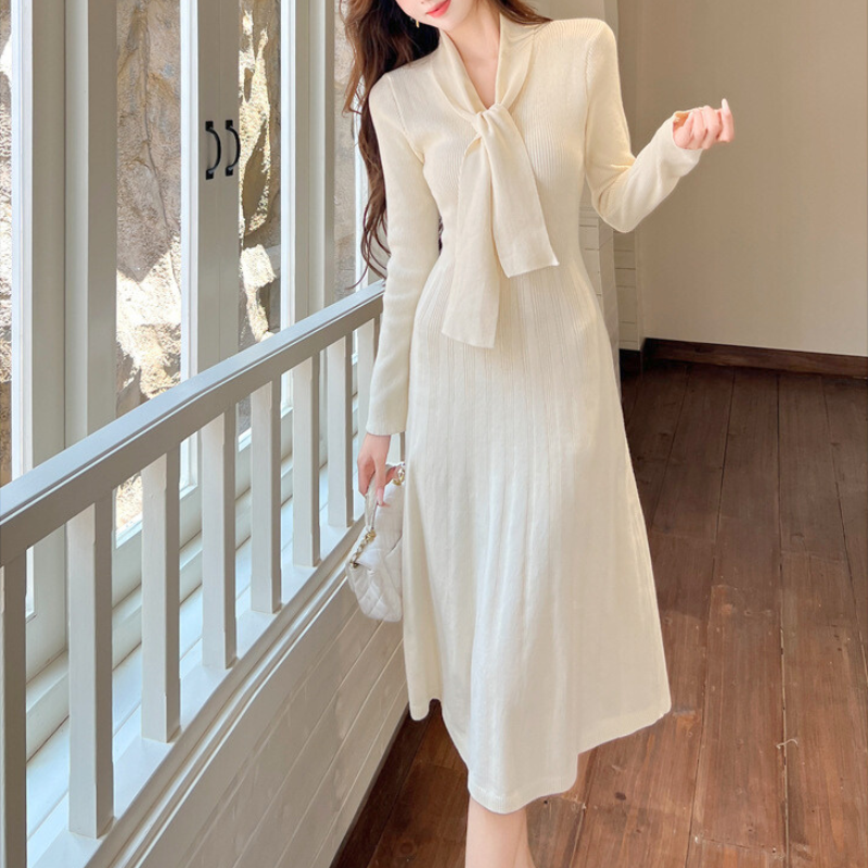 ホワイトのリボンタイリブニットワンピースを着た女性|清楚で上品な秋冬デートコーデ