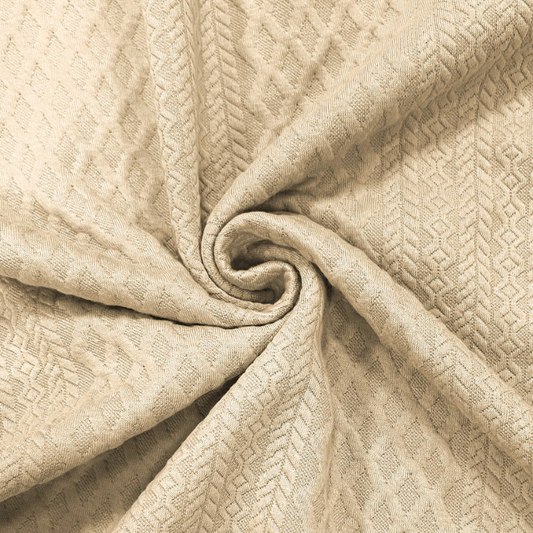 幾何柄が立体的に映えるベージュの厚手ジャカード生地アップ