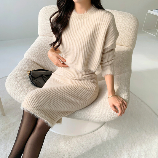 上品なベージュのニットワンピースにショート丈セーターを重ねた清楚系デートコーデ。