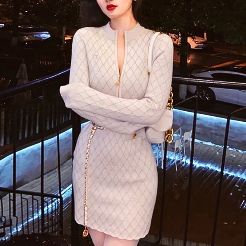 アイボリーのフロントジップニットワンピース。屋外で腕を前で組んだ正面。身頃から裾までのひし形柄