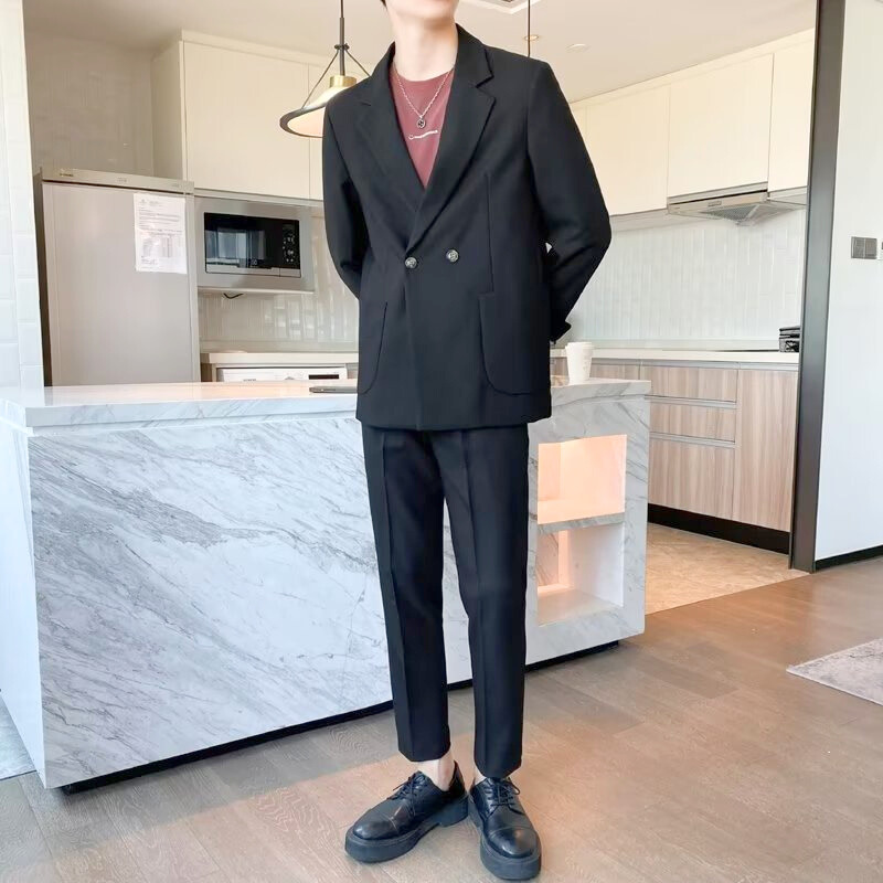 ブラックのスーツを着た男性がキッチンに立っている姿