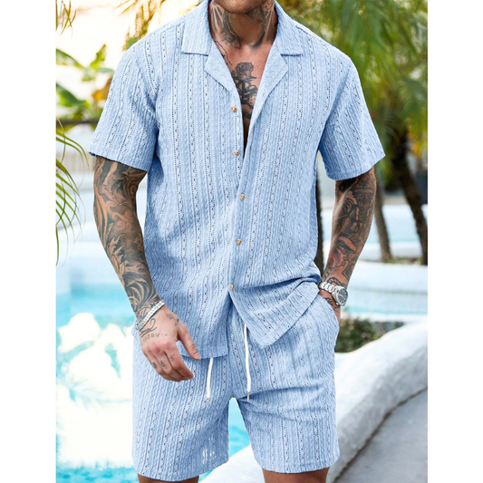 サックスブルーの透かし柄開襟半袖シャツ＆ショートパンツセットアップを着用したメンズ全身コーデ画像