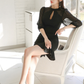 タイトシルエットと裾フリルが映えるブラックミニワンピースの下半身画像